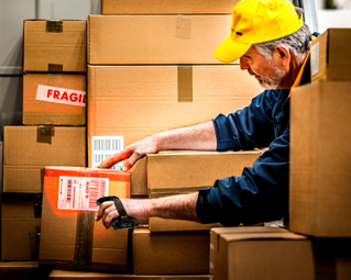 Driver using Handheld to scan packages